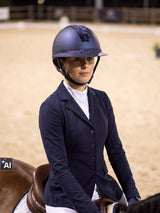 Rider wearing a navy Samshield Miss Shield 2.0 Cosmic Night helmet riding in the arena (AI)