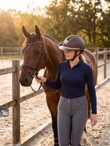 Rider wearing a brown Samshield Miss Shield 2.0 Crystal Fabric Gold helmet leading her horse along the fence (AI)