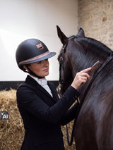 Rider wearing a Samshield Miss Shield 2.0 Rose Gold helmet grooming her horse in the stable (AI)