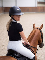 Rider wearing a Samshield Miss Shield 2.0 Shadowmatt Night Shade helmet riding in the arena