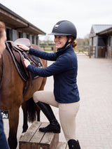 Rider wearing a Samshield Miss Shield 2.0 Shiny Crystal Fabric 5 Swaro helmet at the mounting block (AI)
