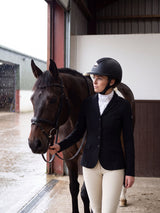 Rider wearing a Samshield Shadowmatt 2.0 Crystal Fabric helmet with her horse on a rainy day
